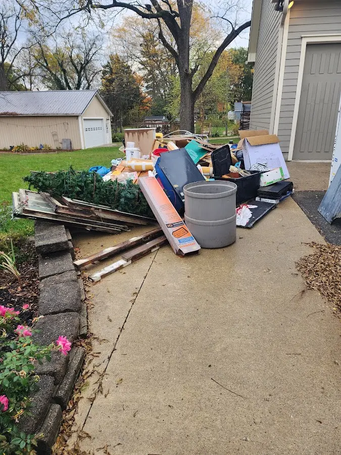 Dumpster being loaded with debris for Roofing Dumpster Rental in Fridley